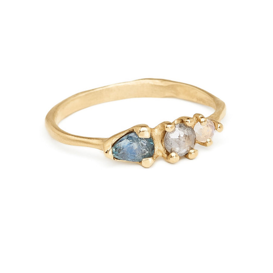 Montana blue sapphire pear cut with grey diamond and moonstone ring. Three stone ring in recycled 14kt yellow gold. 