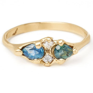 pear cut Montana blue and teal sapphire ring set with grey princess cut diamonds in our unique hand carved 14kt gold setting 