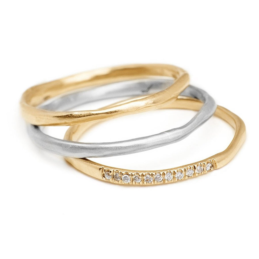 thin textured yellow and white gold stacking ring with pave diamonds