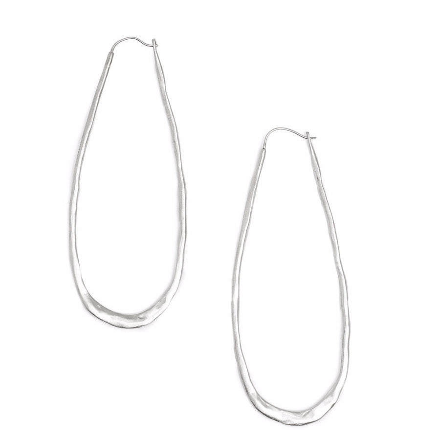Long oval silver hoop earrings with a hammered texture 
